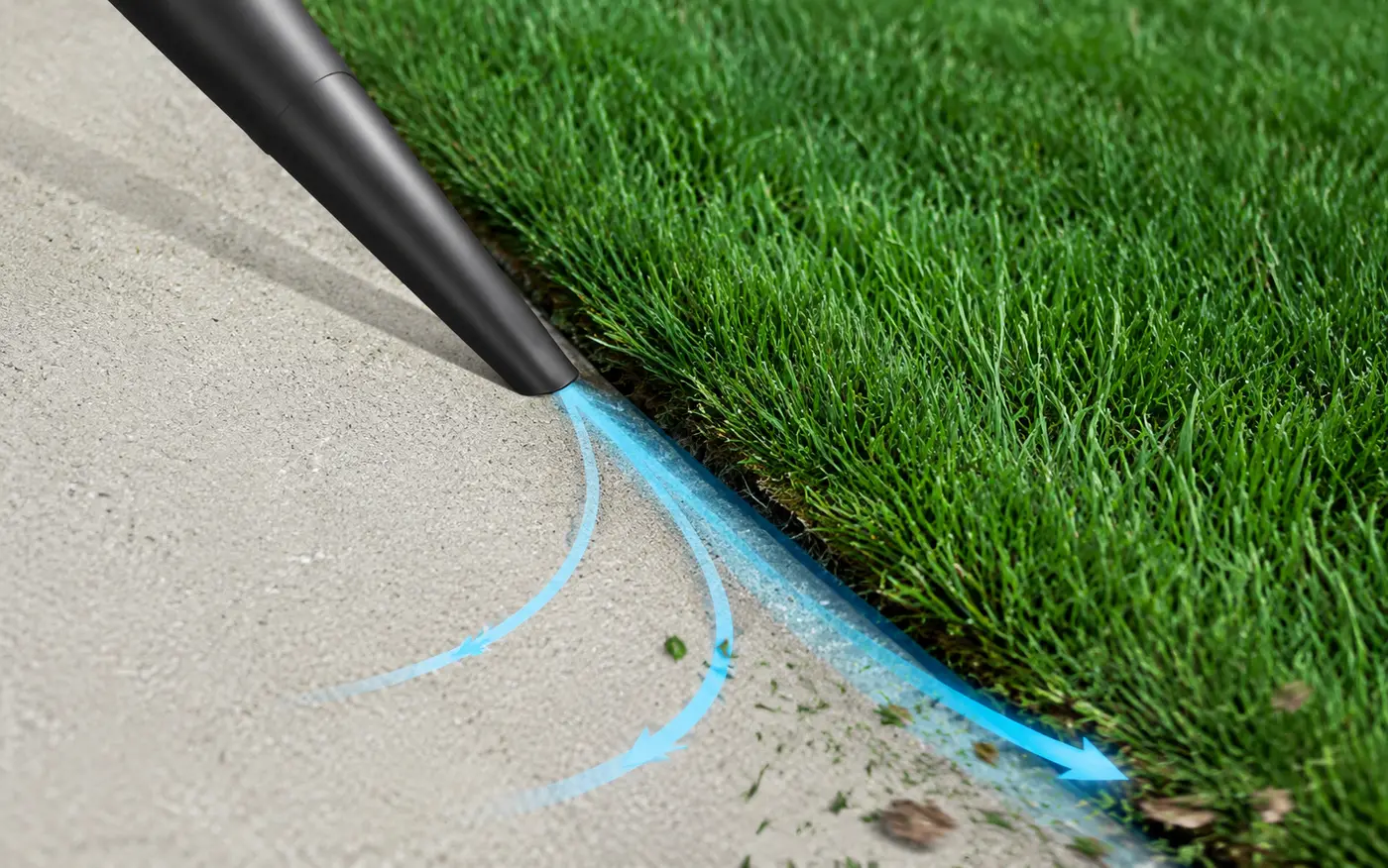 Edge Blaster airflow concept showing focused air entering the narrow seam between a sidewalk and lawn